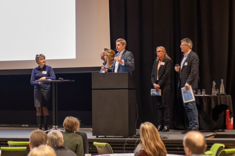 Representanter fra spesialistgruppen på en scene under årets BIO-seminar.