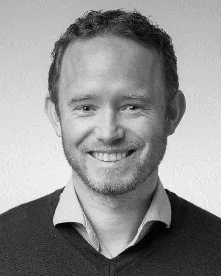 En mann som smiler til kameraet