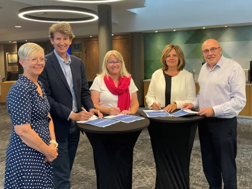 En gruppe mennesker som står rundt et bord