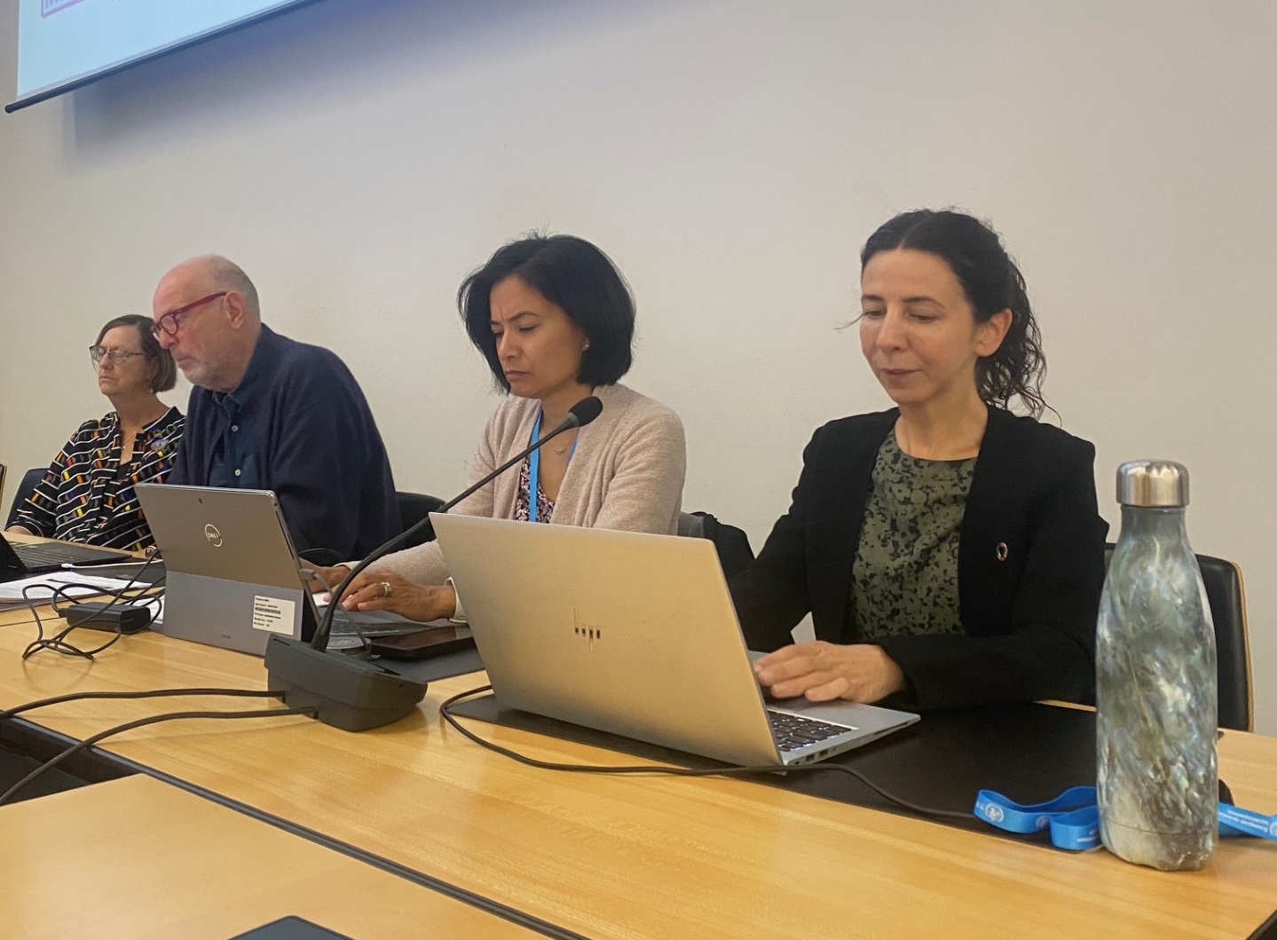 En gruppe mennesker som sitter ved et bord med bærbare datamaskiner